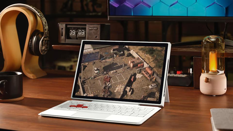 A white PC handheld with a kickstand and detachable keyboard.