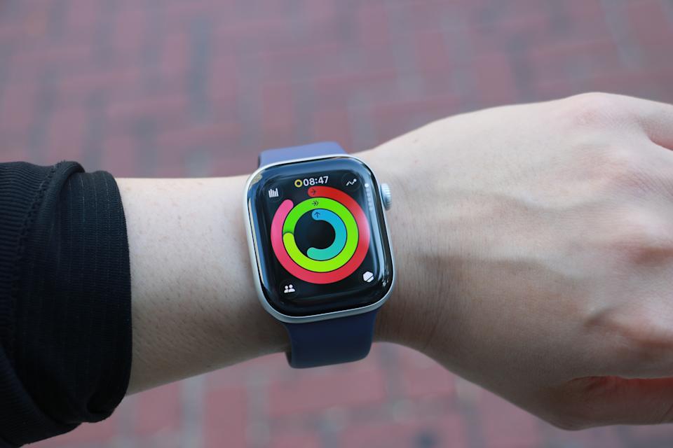 The Apple Watch Series 11 on a wrist, showing the watchOS 26 activity rings page.